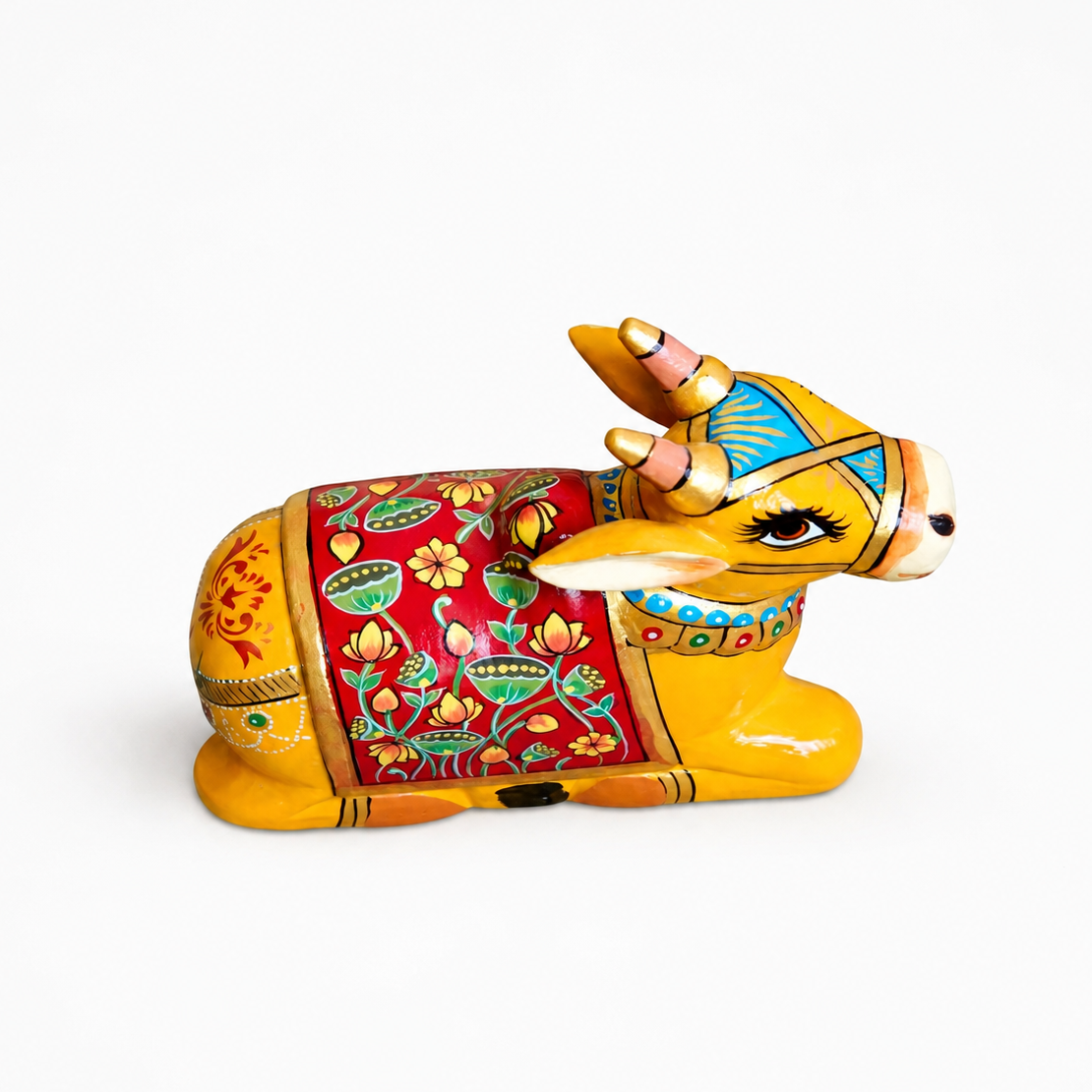 Decorative cow/nadi figurine with colorful patterns on a white background