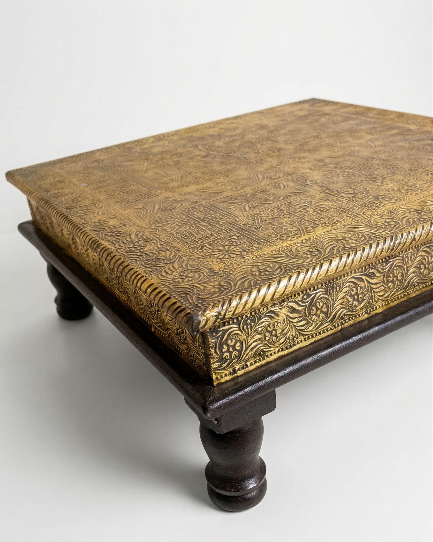 Decorative wooden box with intricate gold patterns on a white background