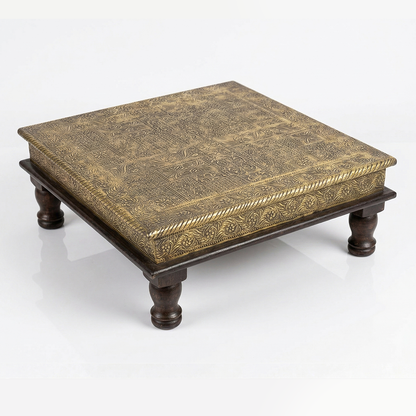 Decorative wooden table with intricate carvings on a white background