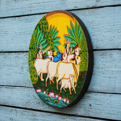 Decorative plate with a colorful scene of people on horses in a natural setting, placed on a wooden surface.