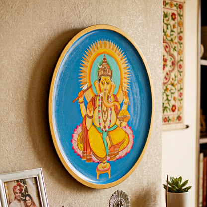 Decorative plate with a colorful Lord Ganesh depiction of a deity on a blue background.