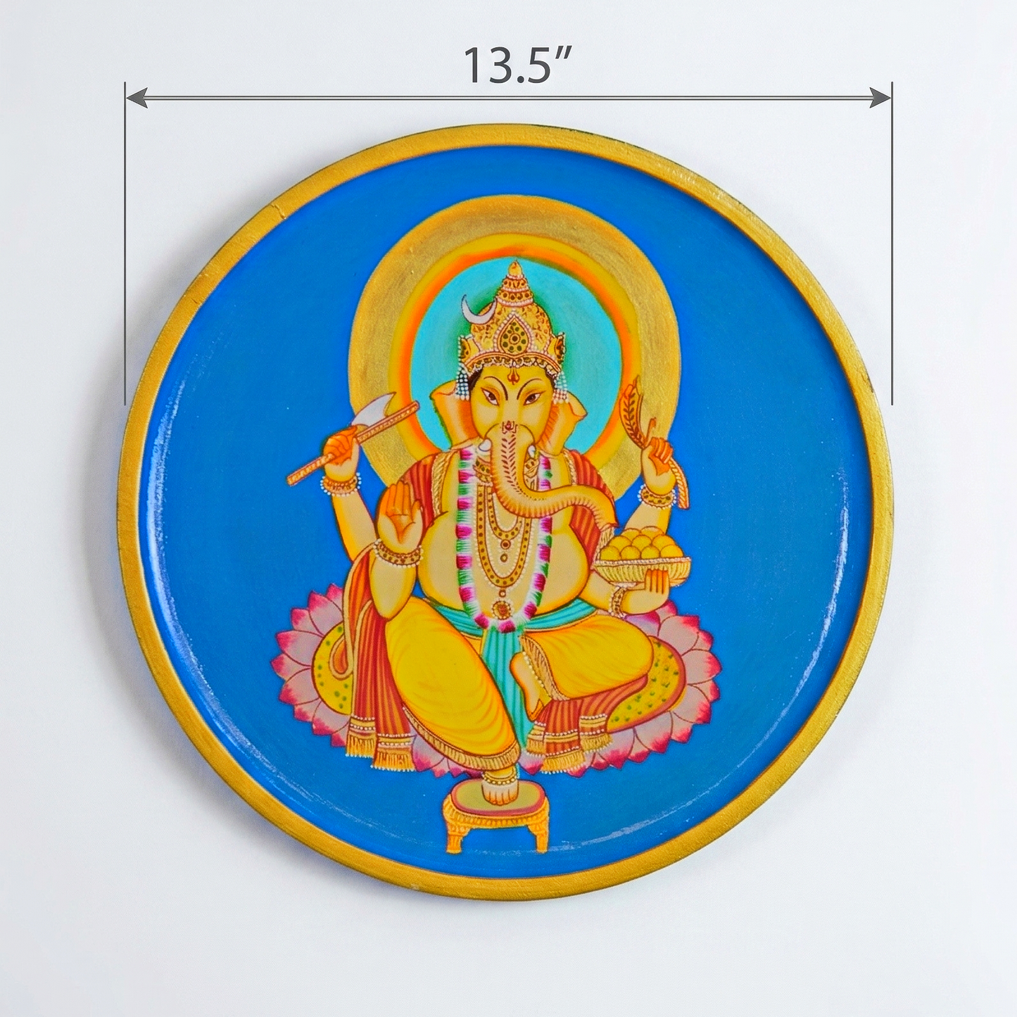 Decorative plate with a colorful Lord Ganesh depiction of a deity on a blue background.