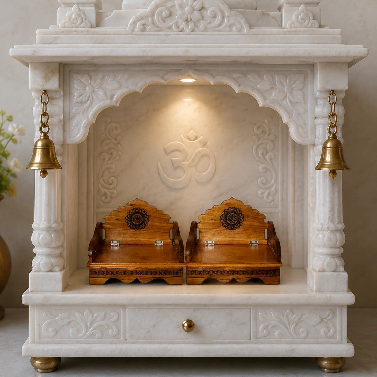 White marble pooja unit with wooden altars and gold accents on a neutral background