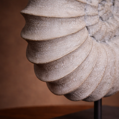 Close-up of a textured stone sculpture with concentric circles on a blurred background