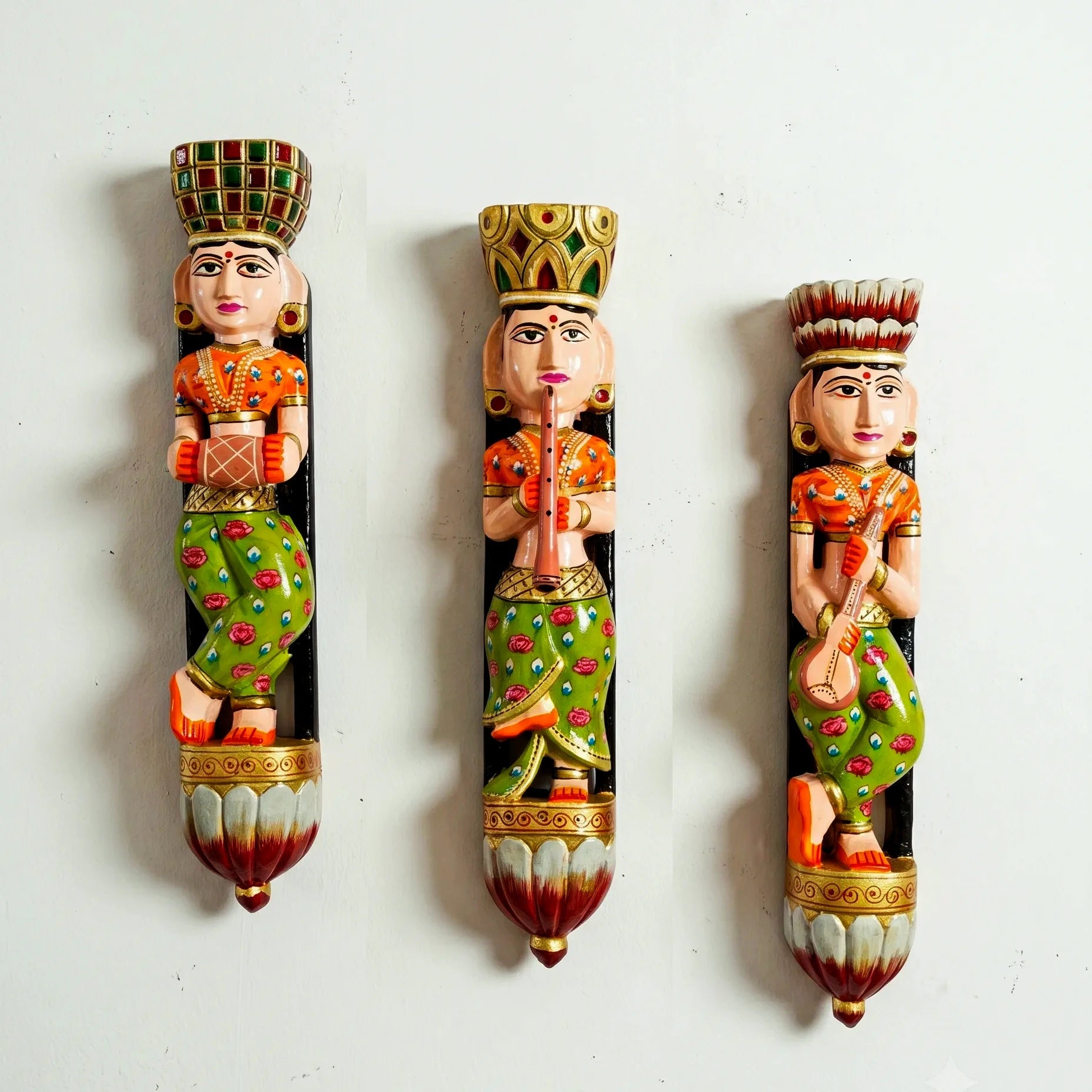 Three decorative figurines with intricate designs on a white background