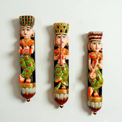 Three decorative figurines with intricate designs on a white background
