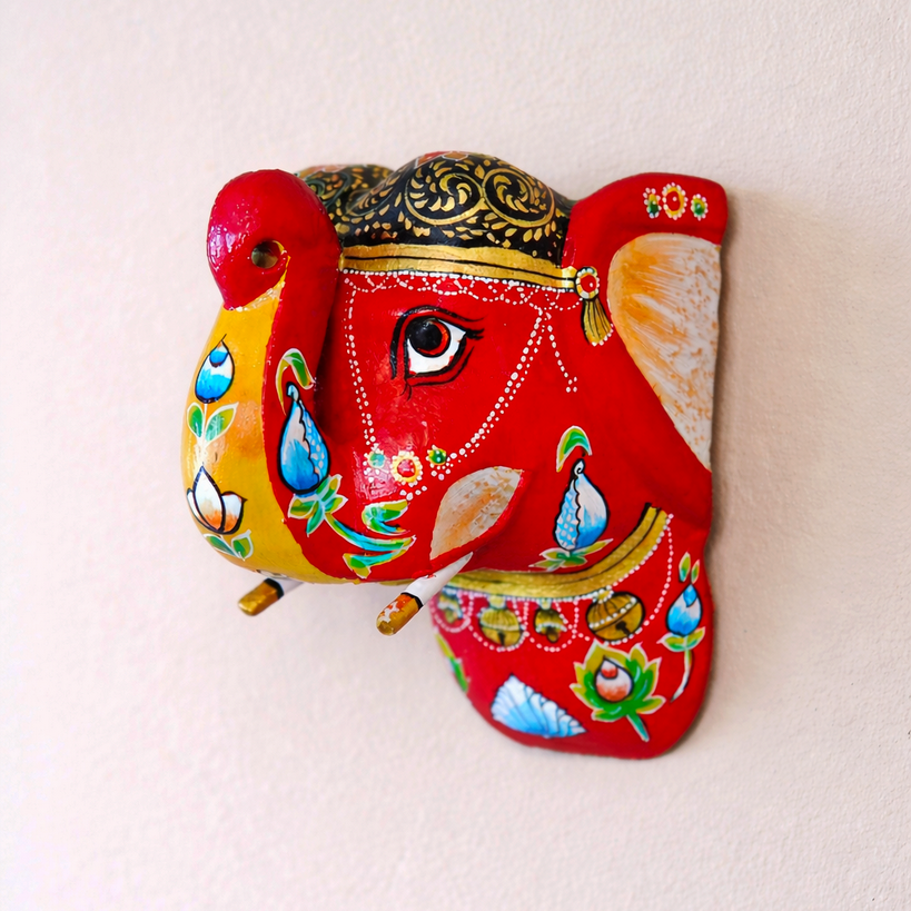 Decorative wall hanging of a colorful elephant with intricate designs on a light beige background