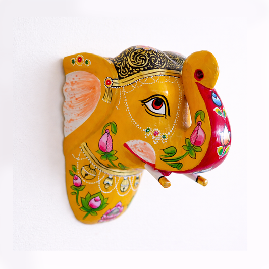 Decorative elephant wall hanging with colorful patterns on a white background