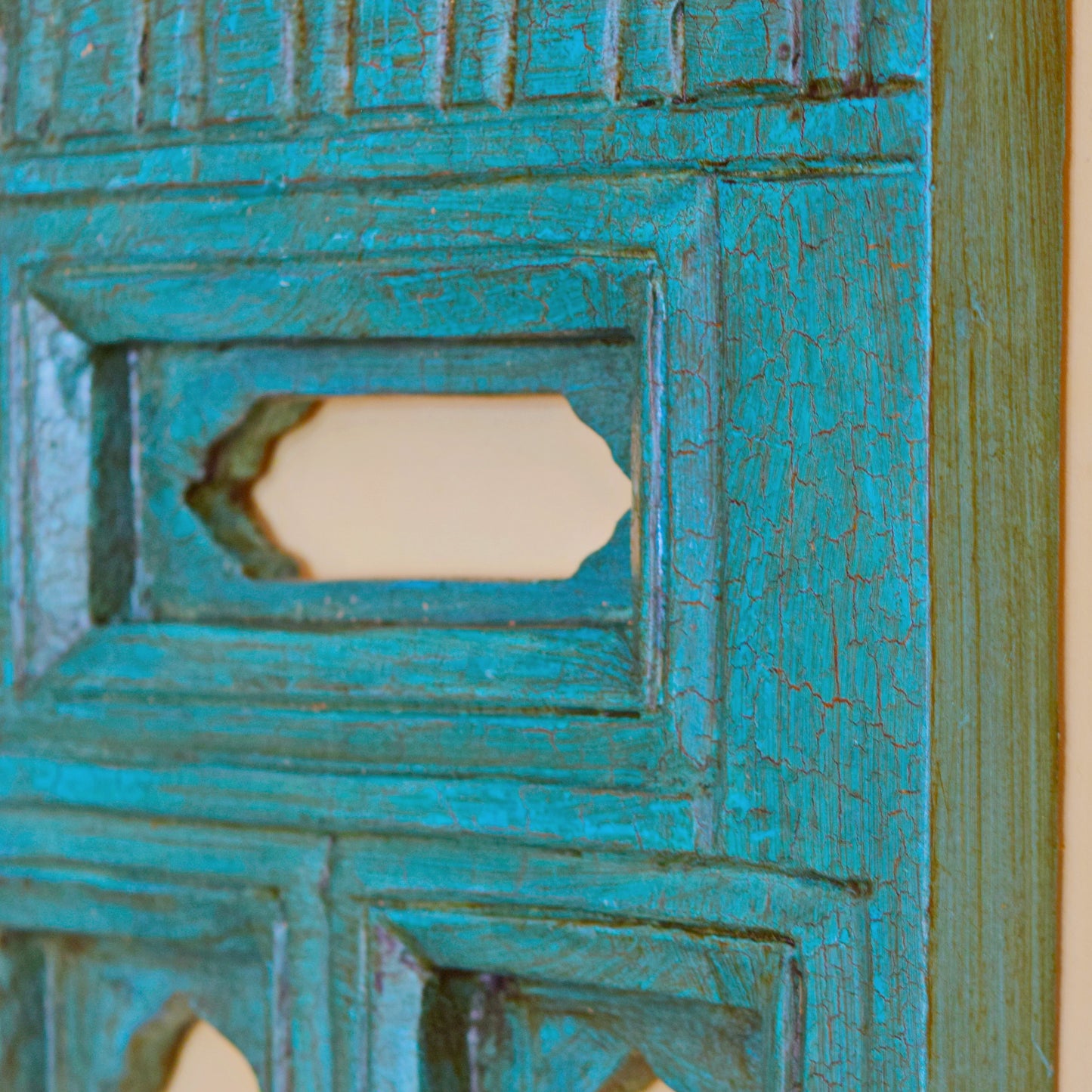Close-up of a textured turquoise surface with geometric patterns