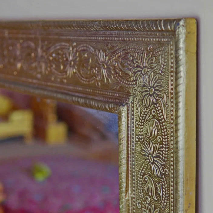 Decorative gold mirror with intricate patterns