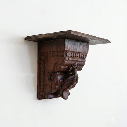 Wooden wall bracket with intricate carvings on a white background