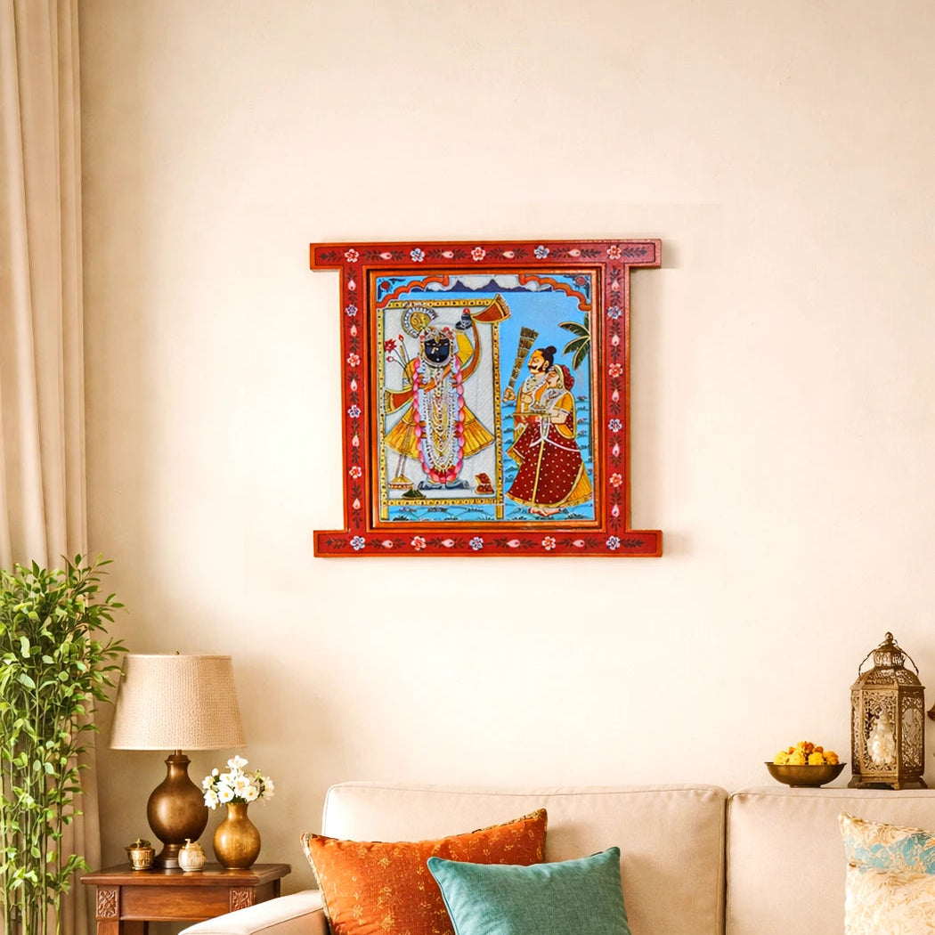 Decorative wall art of a神灵 couple on a wall above a sofa with colorful cushions.