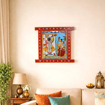 Decorative wall art of a神灵 couple on a wall above a sofa with colorful cushions.