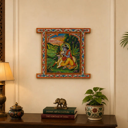 Decorative setup with a framed painting, lamp, books, and plant on a wooden console table.
